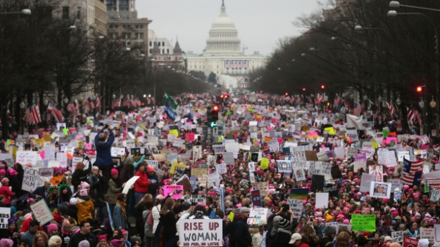 WASHINGTON, DC - JANUARY 21: Protesters walk during the Women's March on Washington, with the U.S. Capitol in the background, on January 21, 2017 in Washington, DC. Large crowds are attending the anti-Trump rally a day after U.S. President Donald Trump was sworn in as the 45th U.S. president. (Photo by Mario Tama/Getty Images)